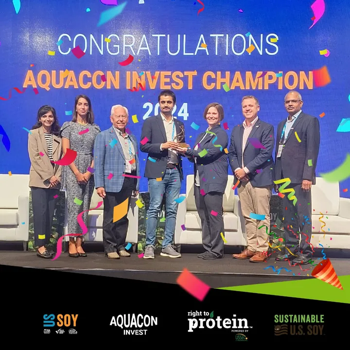 The PanaceaLogics team receiving the Aquacon Invest Champion 2024 trophy on stage in Dubai
